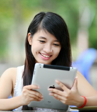 woman reading from a tablet computer